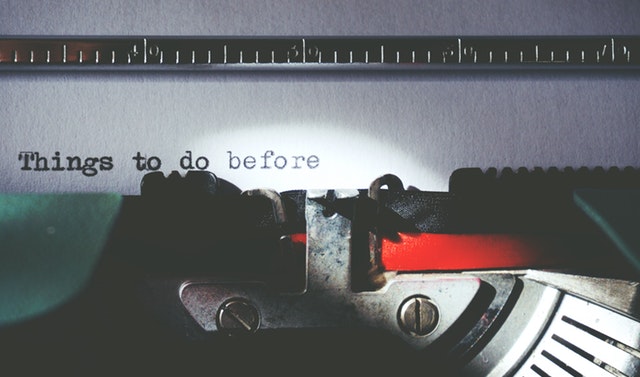 a picture of a typewriter typing a bucket list for couples titled "things to do before..."