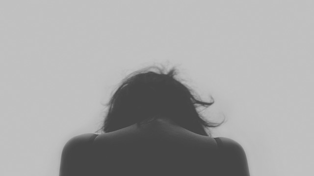 a woman with her head down stressing out because being married to a doctor is anything but glamorous 
