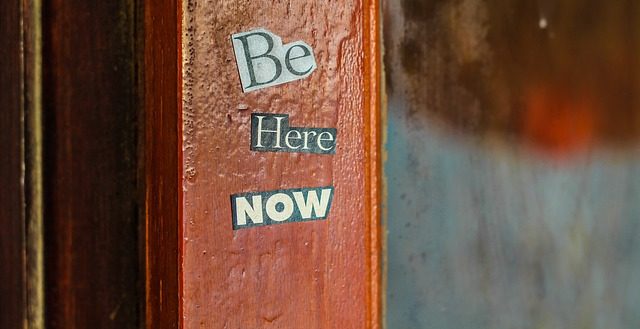 a poster saying be here now