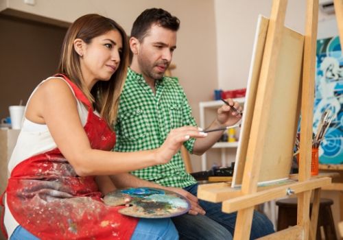 a couple having paint night which is fun activities for couples