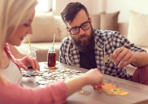 puzzle competition between two people is part of the fun activities for couples