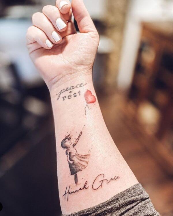 girl releasing red balloon tattoo with infant name
