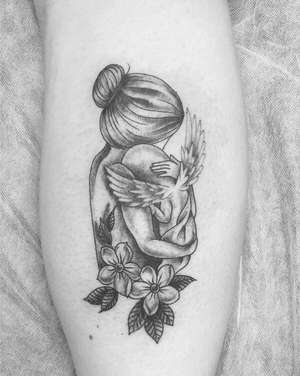 mommy hugging angel baby memorial tattoo with flowers