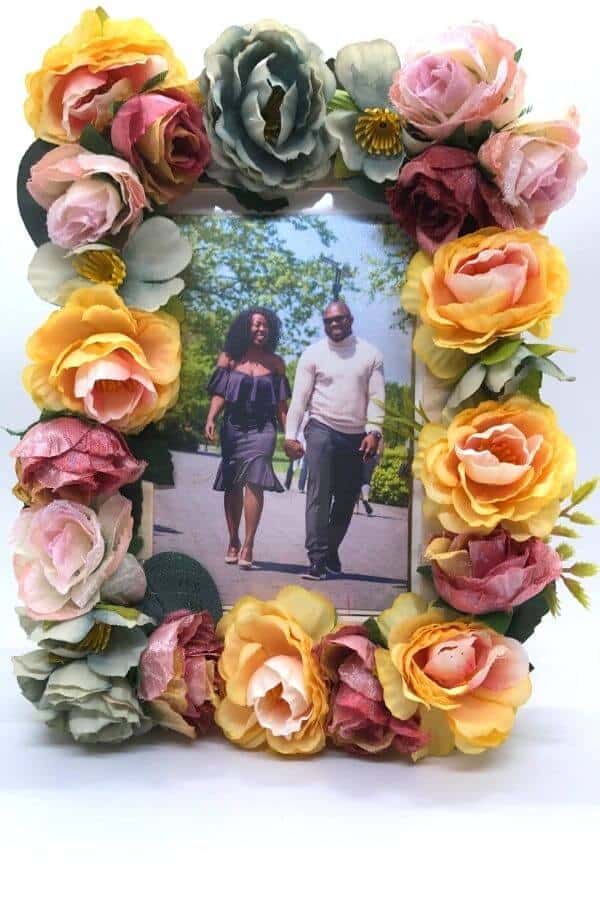 engagement photo in a diy picture frame with flowers