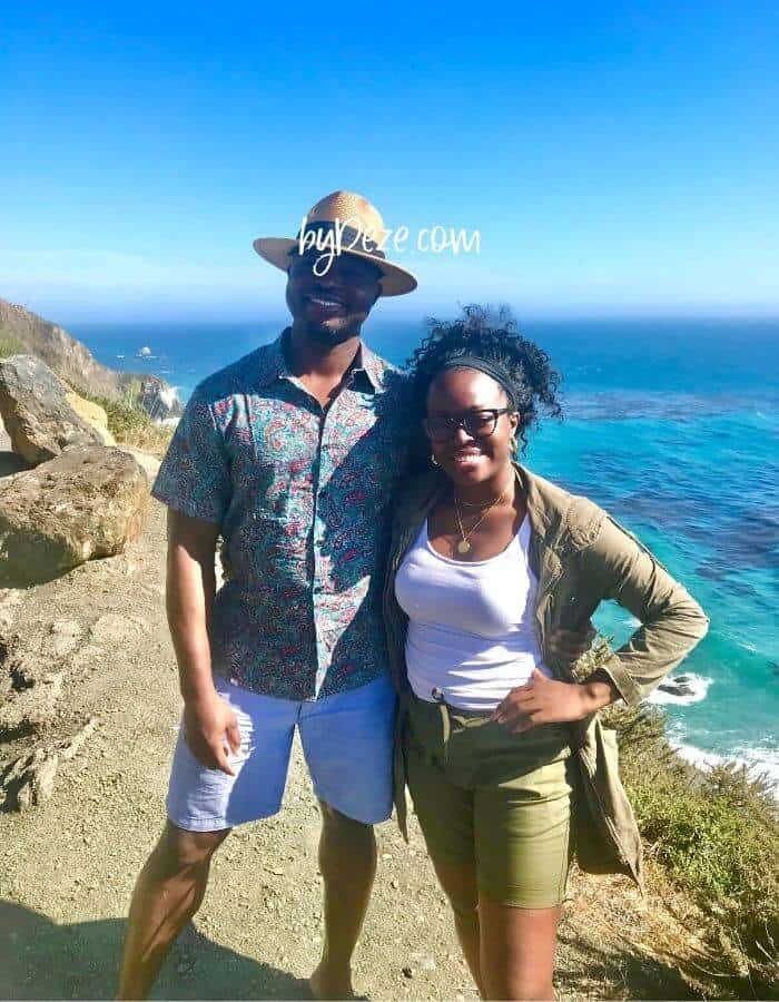 a couple posed on the big sur coastline during road trip