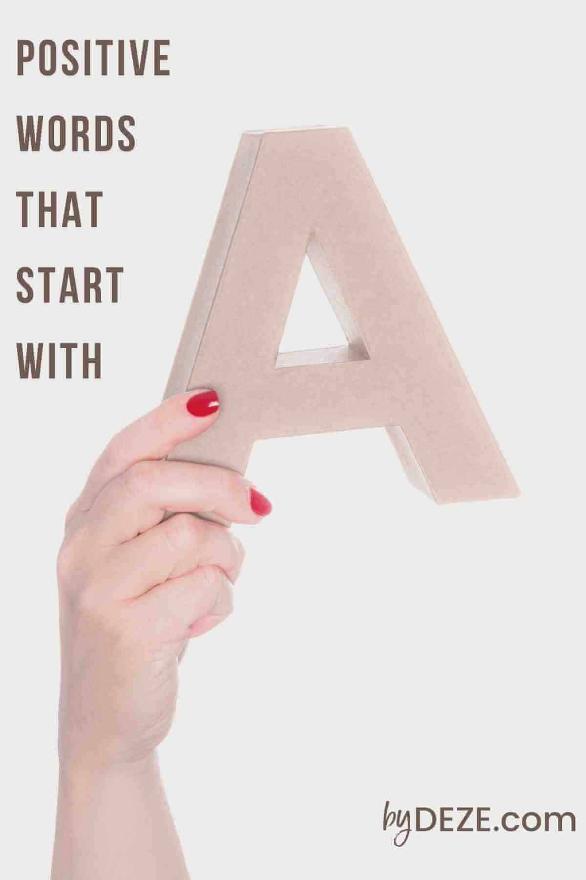 hand holding the letter A